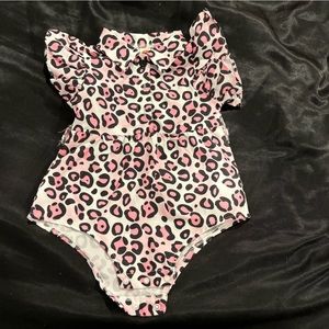 Cute little pink and white body suit for baby’s 6 month